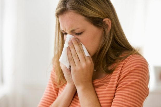 Woman Blowing Her Nose - Woman With a Cold - Beating Seasonal Illness
