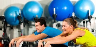Couple Exercising Stretching at the Gym