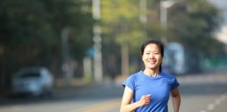 Woman Exercising Running on Road