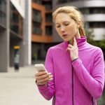 exercise woman timing her pulse on her phone