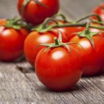 Close-up of fresh, ripe cherry tomatoes on wood