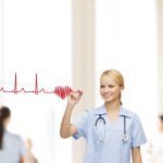 smiling doctor or nurse drawing electrocardiogram